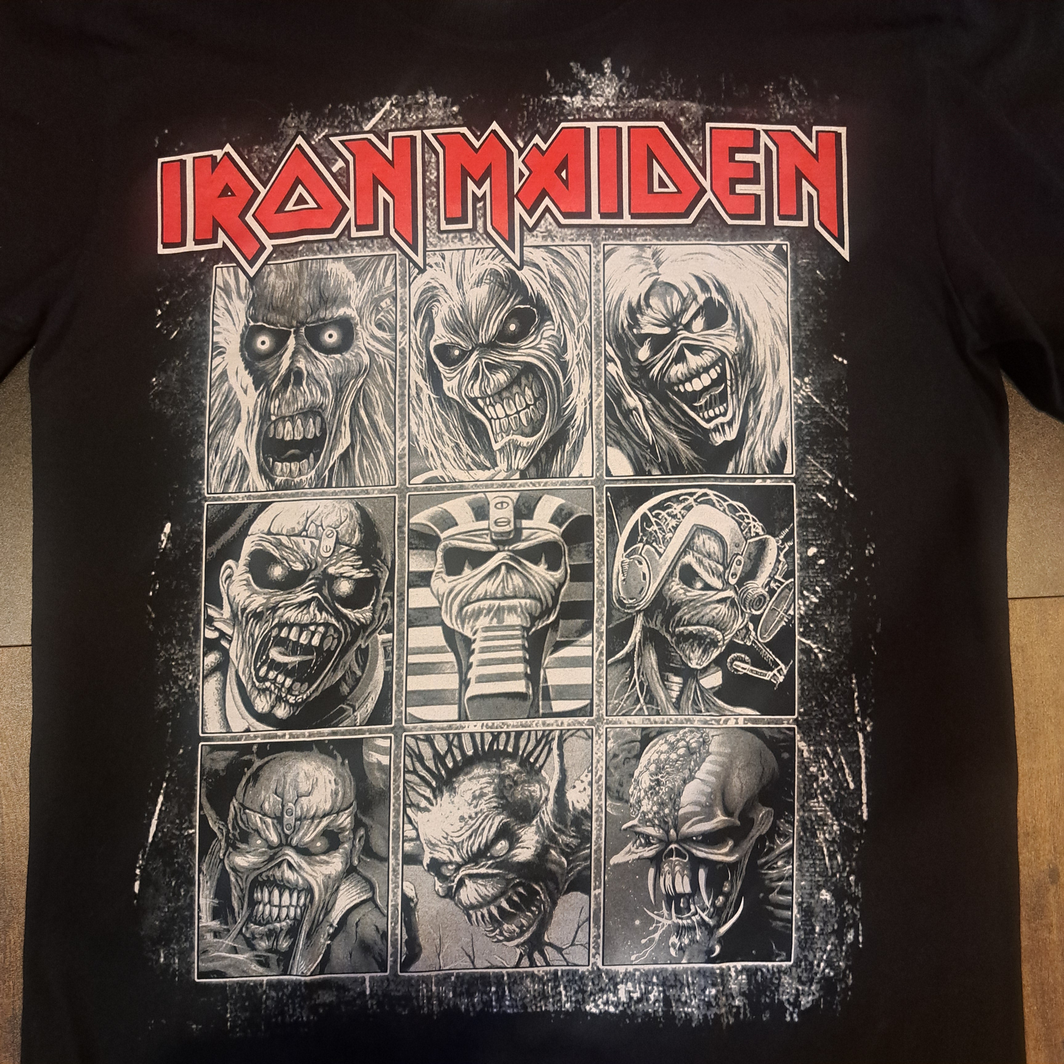 Black t-shirt with Iron Maiden graphic design featuring Eddie on the front and the band's name on the back.