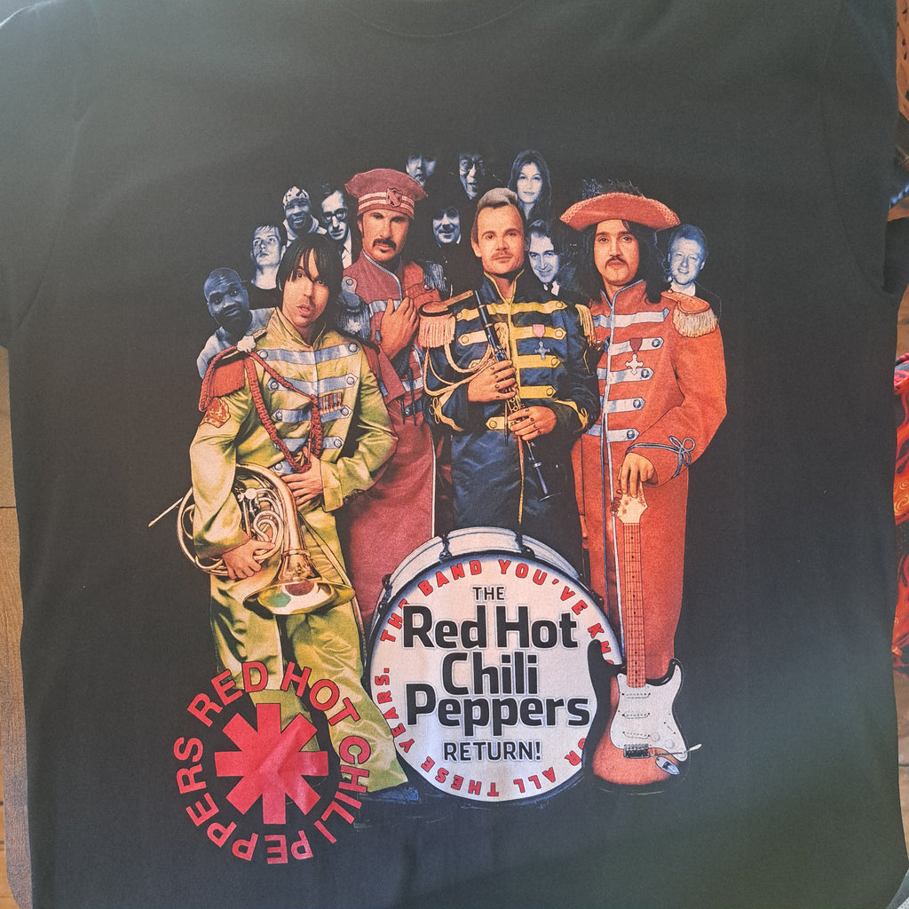 Black t-shirt with Red Hot Chili Peppers graphic design on a dark surface