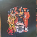 Black t-shirt with Red Hot Chili Peppers graphic design on a dark surface
