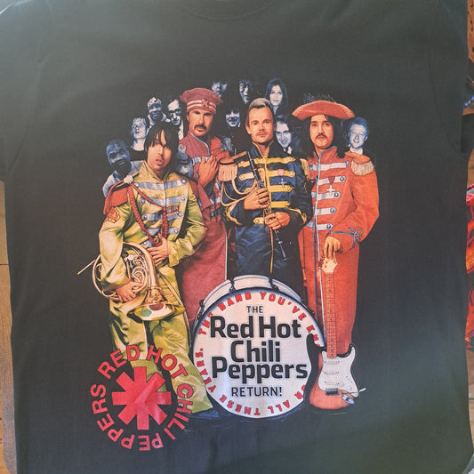 Black t-shirt with Red Hot Chili Peppers graphic design on a dark surface
